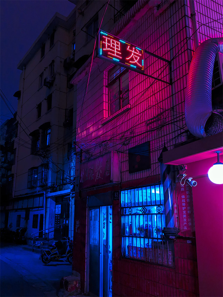 A neon alley with a Chinese sign