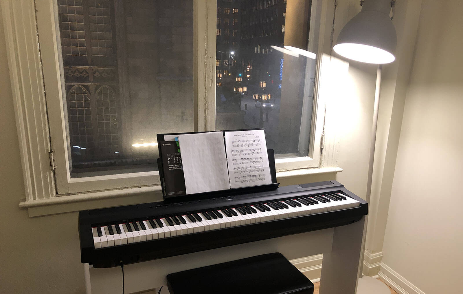 A piano in front of a window